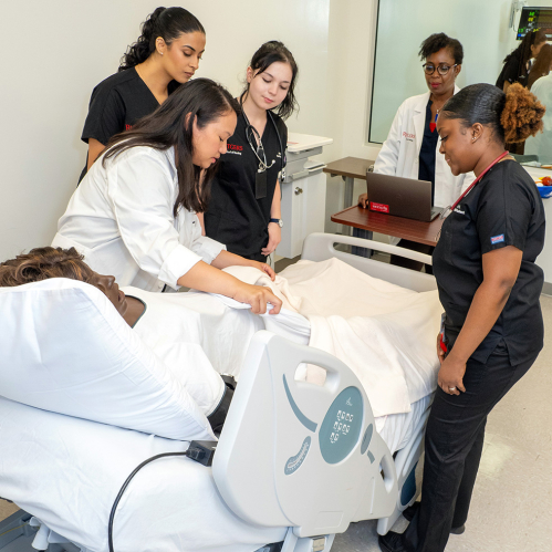 Rutgers school of nursing students practicing on a dummy patient