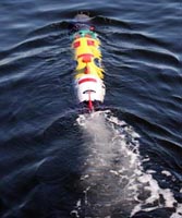 The autonomous underwater vehicle REMUS churns through the water during trials.