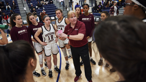 Mary Kinger Coyle talking to her team in a huddle during a game