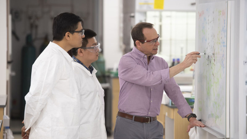 Professor Alan Goldman works with students Arun Shuda (SAS '20) and Xiaoguang Zhou (PhD candidate) 