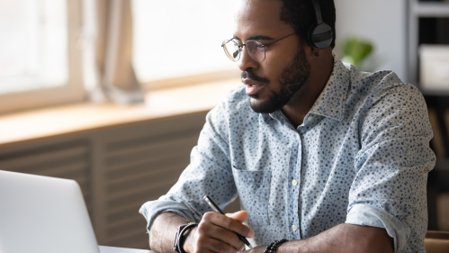 Man sitting at a desk at home and working