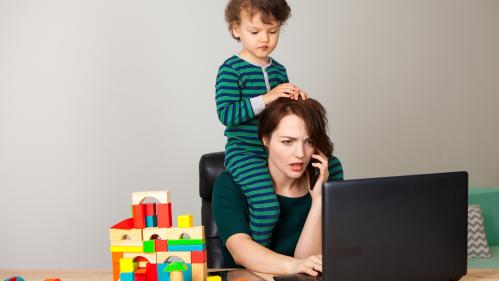 Mom working with child on her shoulders.