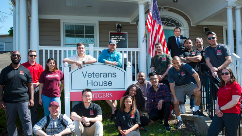 Veterans pose in front of Veterans House
