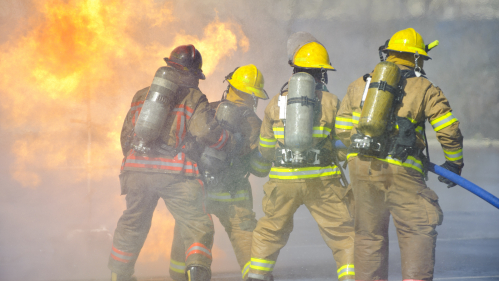 four firefighters putting out a fire