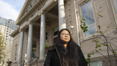 Rashel Reyes in front of the New Brunswick Public Library.