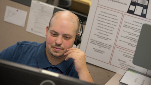 Peer support specialist Matthew Fink in the University Behavioral Health Center call center