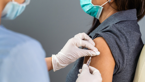 Medical professional injecting vaccine into patient