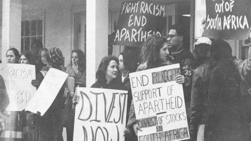 A multiracial group of Rutgers students rally for divestment.