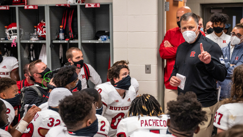 Masked football team meeting with coach Schiano at Michigan State