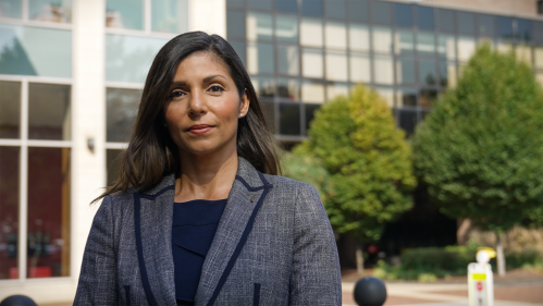 Carolina Cabrera DiGiorgio standing in front of the Rutgers Law School building at Rutgers-Camden