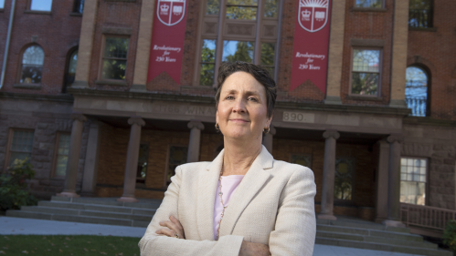 Senior Vice President and Chief Information Officer Michele Norin in front of Old Queens