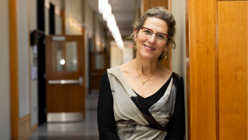 Ellen Goodman standing in a school building 