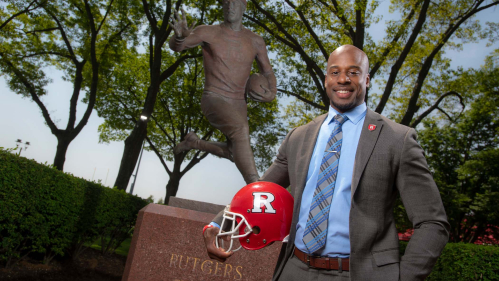 Shawn Tucker holding a football helmet