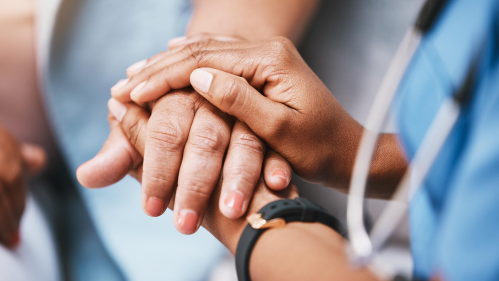 Doctor holding patient hand