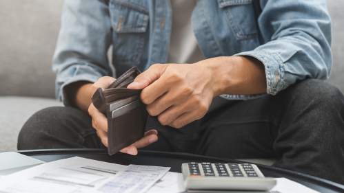person looking at his wallet