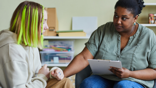 A therapist talking to a youth about their mental health