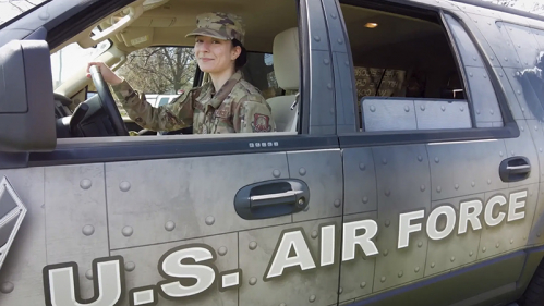 2022 Rutgers School of Nursing graduate Christina Mandriota drives a U.S. Air Force SUV dressed in her fatigues. 