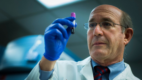 Jeffrey Carson examines blood vial