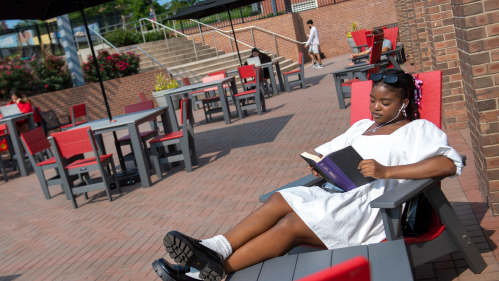 Osariemen Destiny Omoruyi (SAS ’25) sitting on the new patio furniture at the Douglass Student Center.