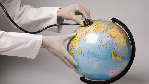 doctor puts stethoscope to globe
