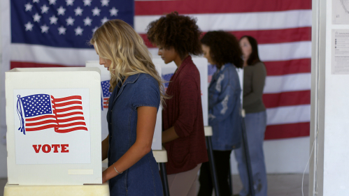 Voters cast a vote at a polling location