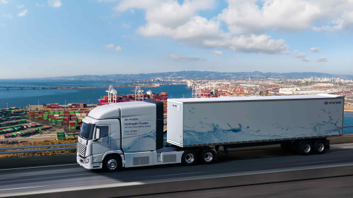 Large tractor trailer races along a highway.