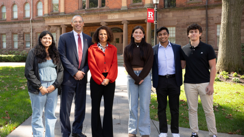 Rutgers President Jonathan Holloway and Edith Cooper pose with students