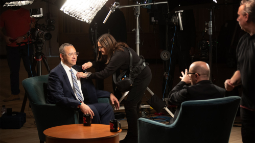 President Hollow being prepped by film crew before an interview
