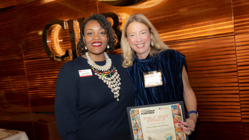 Joan Collier, left, assistant vice president for equity and inclusion, stands with Emily Allen-Hornblower, who is holding her award.