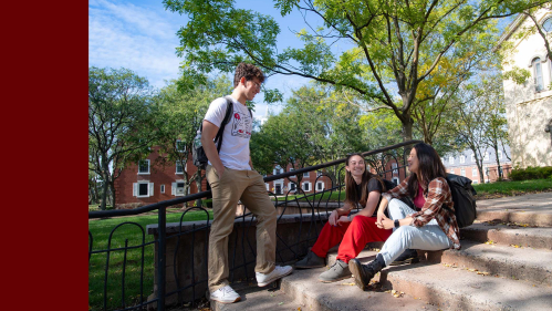 Rutgers students talk on steps near Bishop House on the College Avenue campus.