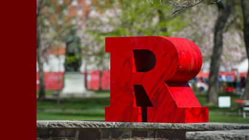 A scarlet "R" sits on a stone and brick wall at Voorhees Hall on College Avenue campus.