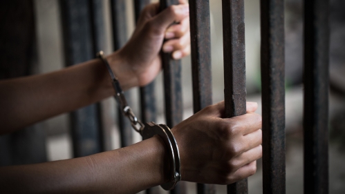 Women in jail in handcuffs