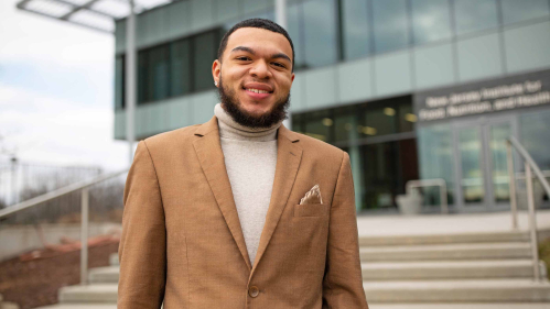 Rutgers student and peer mentor Travis Anane stands outside of the Food Science and Nutritional Sciences Building at 65 Dudley Road, New Brunswick.