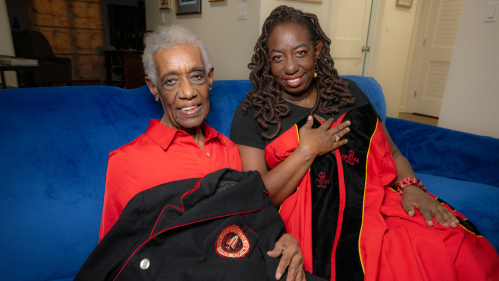 Dr. Inez P. Durham (DC ’57, SSW ’61, GSAPP ’84), holding her New Jersey College for Women jacket, and her daughter Dr. Jennifer Inez Durham (GSAPP ’92) Professor, and special assistant for GSAPP Dean, holding a Rutgers commencement gown, in their Plainfield home.