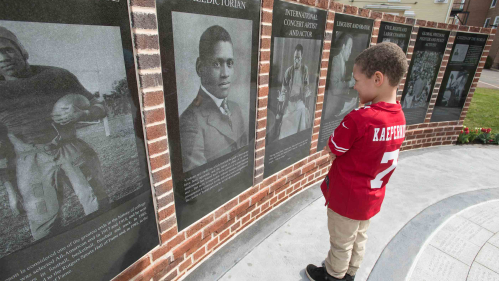 In this 2019 photo, Kristopher Dabrowski looks at one of the granite panels at Paul Robeson Plaza on Voorhees Mall.