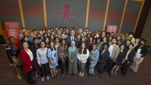 President Jonathan Holloway poses with students at the Rutgers Summer Service Internship Initiative launch event on May 19, 2022