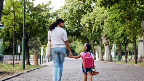 mother walks in park with daughter
