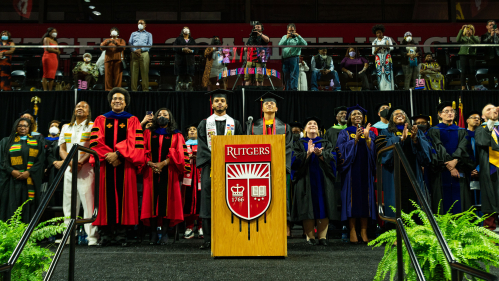 students Jonathan Freire and Jordany Arias with university leaders on stage