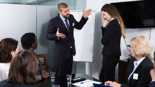 man and woman arguing during office presentation