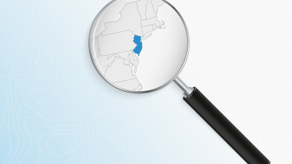 Magnifying glass on a map highlighting the state of New Jersey