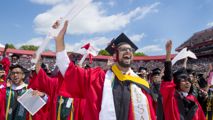 Graduates cheering at commencement ceremony