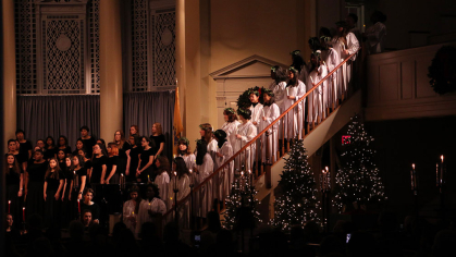 Students singing in choir at the Rutgers Douglass Yule Log ceremony