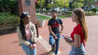 Rutgers students standing outside during a conversation