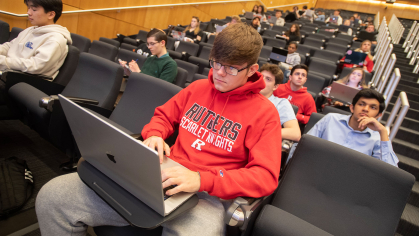 Rutgers student on a laptop during class