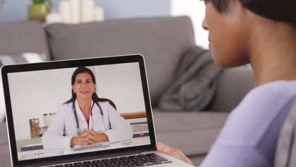 Patient watches video with doctor on laptop