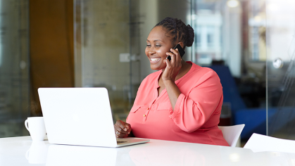 Woman calls OneSource from her office desk. 