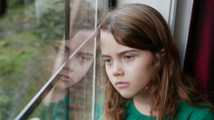 Child looks out the window 