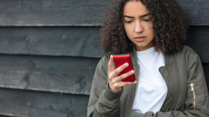 Teenage girl looking at her cellphone