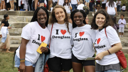 Four Douglass College students standing together wearing I love Douglass t-shirts