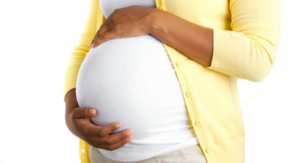 pregnant woman holds stomach